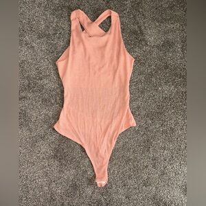 Chic Pink Asymmetrical Bodysuit with Ribbed Texture